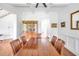 Dining room featuring hardwood floors, coffered ceiling, and a display cabinet at 6250 Moinear Ln, Chapel Hill, NC 27514