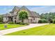 Stately home featuring a three car garage and long concrete driveway at 6250 Moinear Ln, Chapel Hill, NC 27514