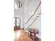 Bright foyer with high ceilings, hardwood floors, staircase, entry door and pendant lighting at 6250 Moinear Ln, Chapel Hill, NC 27514