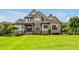 Beautiful, professionally landscaped home with stone and a large, well-manicured front yard at 6250 Moinear Ln, Chapel Hill, NC 27514