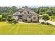 Charming stone-and-siding home featuring manicured landscaping and a lush green lawn at 6250 Moinear Ln, Chapel Hill, NC 27514