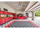 Spacious garage featuring epoxy floors, red cabinets, and ample lighting at 6250 Moinear Ln, Chapel Hill, NC 27514