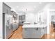 Modern kitchen featuring gray cabinets, stainless steel appliances, and large island at 6250 Moinear Ln, Chapel Hill, NC 27514