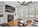 Cozy living room featuring fireplace, TV, custom cabinets, plantation shutters and hardwood floors at 6250 Moinear Ln, Chapel Hill, NC 27514