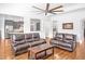 Open-concept living room with hardwood floors, access to the kitchen, and comfortable seating at 6250 Moinear Ln, Chapel Hill, NC 27514