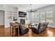 Spacious living room with fireplace, TV, custom shelves, plantation shutters and hardwood floors at 6250 Moinear Ln, Chapel Hill, NC 27514