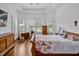 Spacious bedroom featuring hardwood floors, large windows with wooden shutters and light walls at 6250 Moinear Ln, Chapel Hill, NC 27514
