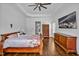 Bright bedroom featuring hardwood floors, tray ceiling and large dresser at 6250 Moinear Ln, Chapel Hill, NC 27514