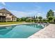 Large in-ground pool with stone deck, cabana, lounge chairs, and lush landscaping, perfect for relaxation at 6250 Moinear Ln, Chapel Hill, NC 27514