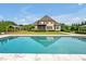 Inviting pool with stone surroundings, complemented by an outdoor cabana and manicured backyard at 6250 Moinear Ln, Chapel Hill, NC 27514
