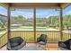 Screened-in porch offers backyard view of the swimming pool and green manicured lawn at 6250 Moinear Ln, Chapel Hill, NC 27514