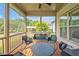 Screened porch featuring black wicker patio furniture and green lawn at 6250 Moinear Ln, Chapel Hill, NC 27514