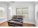 Sitting room features a dark brown leather recliner and window with white shutters at 6250 Moinear Ln, Chapel Hill, NC 27514