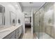Bathroom with double sinks, vanity, and glass-enclosed shower at 6313 Kayton St, Raleigh, NC 27616