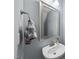 Powder room featuring a stylish vanity, sink, mirror, and towel rack at 6313 Kayton St, Raleigh, NC 27616