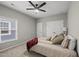 Modern bedroom with a ceiling fan, plush carpet, and ample closet space at 6313 Kayton St, Raleigh, NC 27616