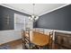 Formal dining room featuring wainscoting, hardwood floors, and a classic chandelier at 6313 Kayton St, Raleigh, NC 27616