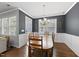 Inviting dining area with a wooden table, six chairs, and natural light streaming through the windows at 6313 Kayton St, Raleigh, NC 27616