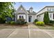 Charming cottage-style home featuring gray siding, a blue front door, and well-maintained landscaping at 6313 Kayton St, Raleigh, NC 27616