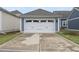 Detached garage featuring a white door, concrete driveway, and clean design at 6313 Kayton St, Raleigh, NC 27616