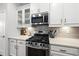 Stylish kitchen featuring white cabinets, stainless steel appliances, and a tiled backsplash at 6313 Kayton St, Raleigh, NC 27616