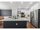 Bright kitchen featuring a large island with a sink, stainless steel appliances, and hardwood floors at 6313 Kayton St, Raleigh, NC 27616