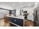 Spacious kitchen with a large island, stainless steel appliances, and a dining area nearby at 6313 Kayton St, Raleigh, NC 27616
