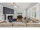 Bright living room featuring a fireplace, plush sectional sofa, and large windows at 6313 Kayton St, Raleigh, NC 27616