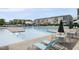Large swimming pool with lounge chairs, tables, and umbrellas in a community setting at 6313 Kayton St, Raleigh, NC 27616