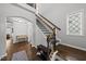 Elegant staircase with wooden steps, iron railings, and natural light from a nearby window at 6313 Kayton St, Raleigh, NC 27616