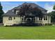 Large backyard showcasing the deck, lush green lawn, and mature landscaping, creating a private and serene outdoor space at 6553 Vintage Ridge Ln, Fuquay Varina, NC 27526