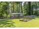 This backyard has a fenced in chicken coop and garden with row covers at 6553 Vintage Ridge Ln, Fuquay Varina, NC 27526