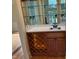 Home wet bar featuring a sink, mirrored backsplash, and wine rack at 6553 Vintage Ridge Ln, Fuquay Varina, NC 27526