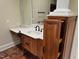Bathroom vanity featuring white countertop and wood cabinets with pull-out storage at 6553 Vintage Ridge Ln, Fuquay Varina, NC 27526