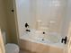Clean bathroom with a tiled shower and tub combination and modern black fixtures at 6553 Vintage Ridge Ln, Fuquay Varina, NC 27526