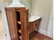 Bathroom vanity featuring white countertop and wood cabinets with pull-out storage at 6553 Vintage Ridge Ln, Fuquay Varina, NC 27526