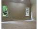 Bright bedroom with neutral carpeting and two windows providing ample natural light and a pleasant view at 6553 Vintage Ridge Ln, Fuquay Varina, NC 27526