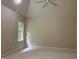 Neutral bedroom with a ceiling fan, vaulted ceiling, and a window offering natural light at 6553 Vintage Ridge Ln, Fuquay Varina, NC 27526