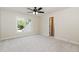 Bedroom featuring neutral carpet, ceiling fan, and window view at 6553 Vintage Ridge Ln, Fuquay Varina, NC 27526