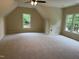 Spacious carpeted bedroom with dormer window, offering natural light and a cozy, inviting atmosphere at 6553 Vintage Ridge Ln, Fuquay Varina, NC 27526