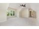 Spacious bedroom with neutral carpet, ceiling fan, and large window views at 6553 Vintage Ridge Ln, Fuquay Varina, NC 27526