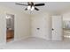 Bedroom featuring neutral carpet, ceiling fan, closet, and en-suite bathroom at 6553 Vintage Ridge Ln, Fuquay Varina, NC 27526