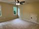 Inviting bedroom with plush carpeting, a ceiling fan, and a dormer access door at 6553 Vintage Ridge Ln, Fuquay Varina, NC 27526