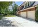 This brick home features a three-car garage and ample concrete driveway parking at 6553 Vintage Ridge Ln, Fuquay Varina, NC 27526