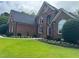 Attractive two-story brick home with a well-kept lawn and garden bed at 6553 Vintage Ridge Ln, Fuquay Varina, NC 27526