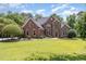 Beautiful brick home with a well-manicured lawn and mature landscaping, showcasing its classic curb appeal at 6553 Vintage Ridge Ln, Fuquay Varina, NC 27526