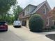 View of the rear of the home with a two-car garage and a paved driveway at 6553 Vintage Ridge Ln, Fuquay Varina, NC 27526