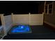 A hot tub with blue lights sits on a deck with decorative fencing around the border at 6553 Vintage Ridge Ln, Fuquay Varina, NC 27526