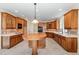 Large kitchen with custom wood cabinets, tile backsplash, and modern stainless steel appliances at 6553 Vintage Ridge Ln, Fuquay Varina, NC 27526