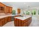 Bright kitchen showcases custom wood cabinetry and a functional center island with cooktop at 6553 Vintage Ridge Ln, Fuquay Varina, NC 27526